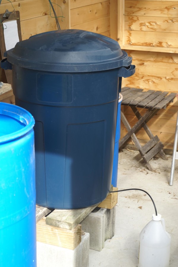 A 32-gallon bokashi composter in a greenhouse.